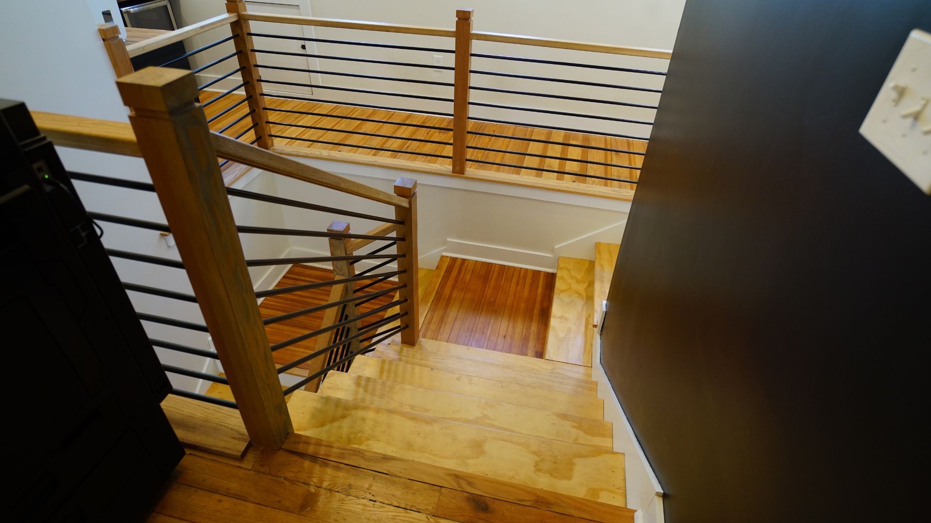 Modern oak and steel staircase connecting two floors at 521 N McDuffie Workspace