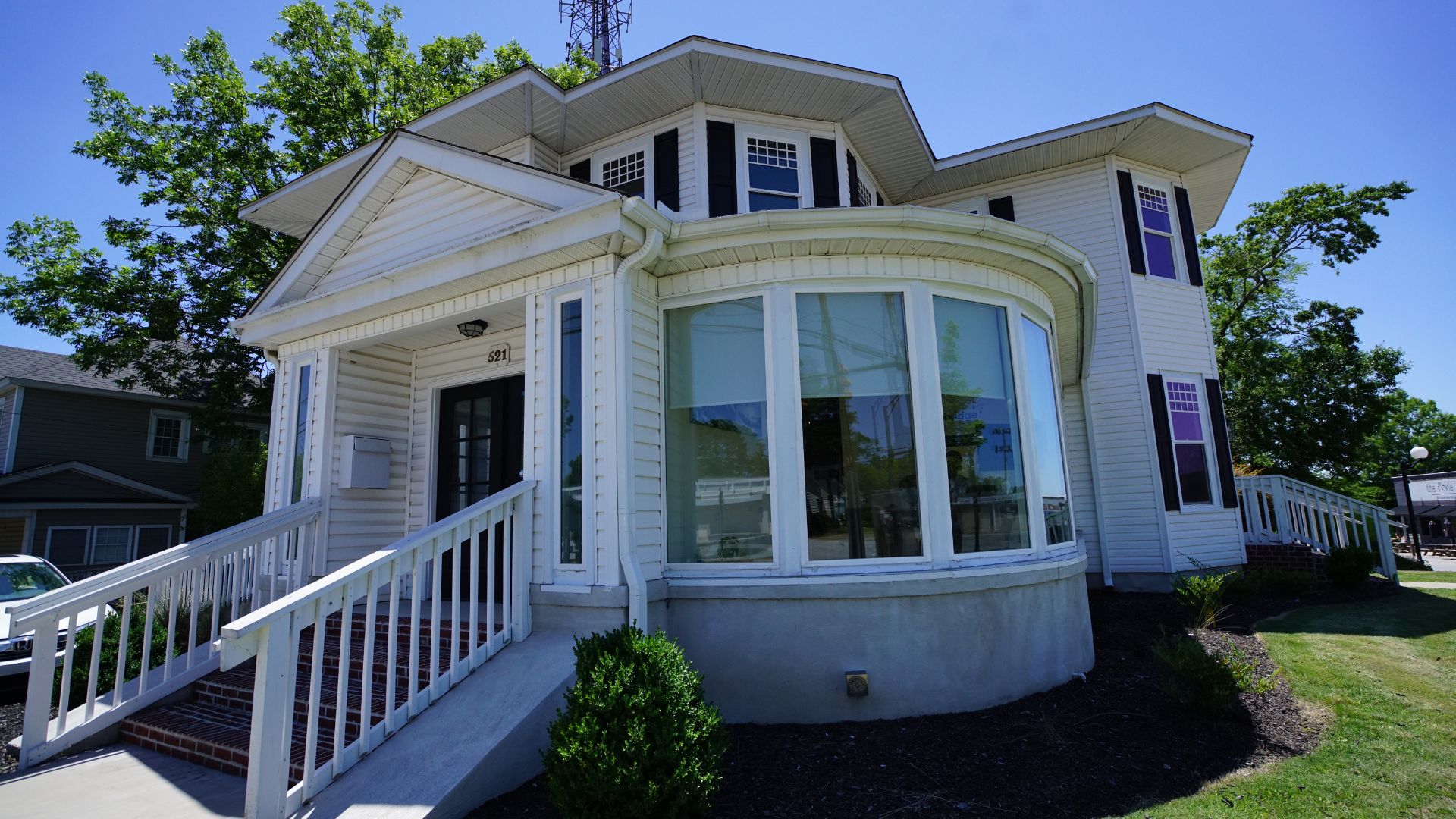 Front and side view of 521 N McDuffie Workspace showing bay windows and covered porch, Anderson SC