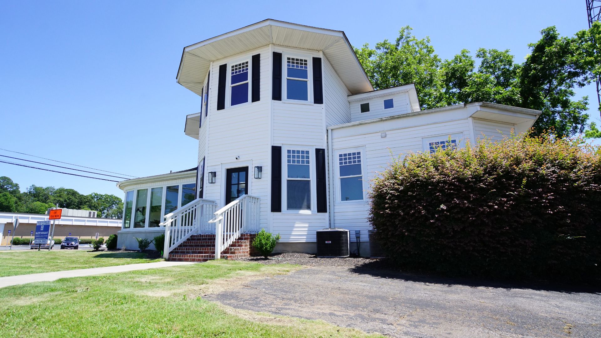 Rear exterior view of 521 N McDuffie Workspace showing two-story structure and parking, Anderson SC