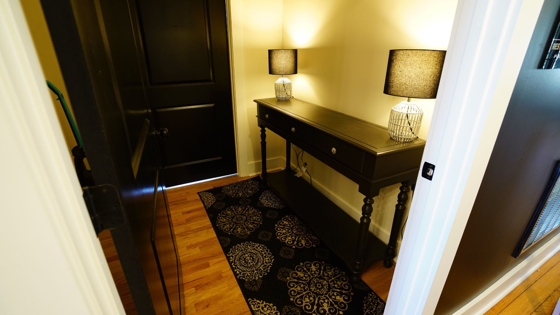 Warm entryway hallway with console table and lamps at 521 N McDuffie Workspace