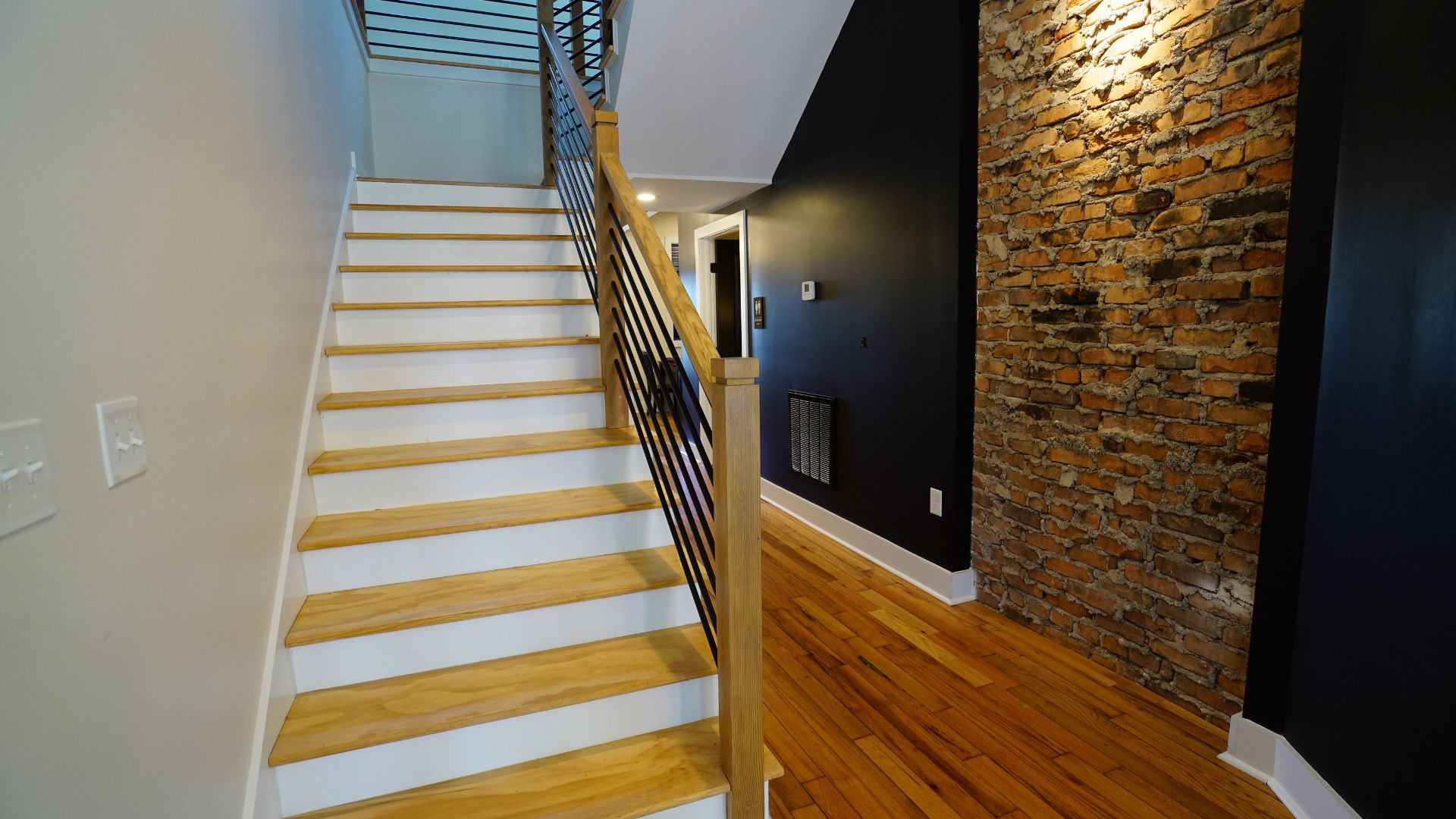 Exposed brick staircase and hallway inside 521 N McDuffie Workspace